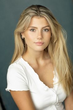 a woman with long blonde hair posing for a photo