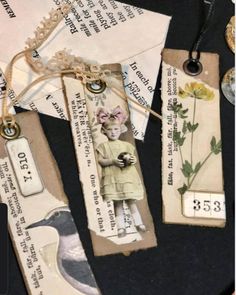 some tags are laying on top of each other with flowers and words attached to them