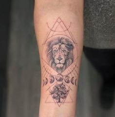 a tattoo on the arm of a person with a lion head and geometrical shapes