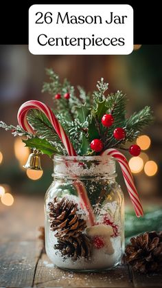 A mason jar centerpiece decorated with Epsom salt, pinecones, holly, bells, and candy canes for a winter wedding. Fairy Lights In Mason Jars Centerpieces, Mason Jars Christmas Centerpieces, Christmas Candy Jars Decoration, Winter Decor Table Centerpiece Ideas, Silver Table Decorations Christmas, Xmas Jars Decoration, Christmas Mason Jar Candle Holders, Cheap Easy Christmas Centerpieces, Pine Cone Christmas Table Centrepiece