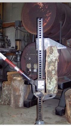 a large piece of metal sitting on top of a wooden table next to some logs