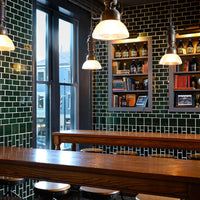 an empty restaurant with wooden tables and stools in front of large windows that look out onto the city