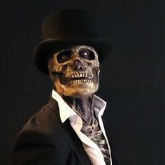 a skeleton dressed up in a top hat and suit