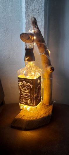 a glass bottle that is sitting on top of a wooden stand with lights around it