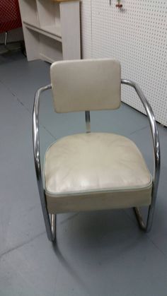 a white chair sitting on top of a gray floor