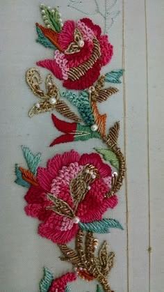 a close up of a flower on a piece of cloth with beads and sequins