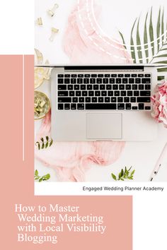 a laptop computer sitting on top of a desk next to pink flowers and greenery