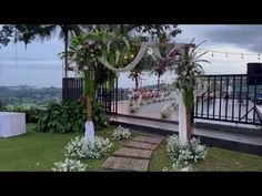 an outdoor ceremony setup with flowers and greenery