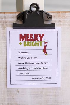 a clipboard with a merry and bright message attached to it