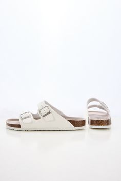 Introducing Maibulun's Signature Double Strap Footbed Sandal in White. Designed for ultimate comfort and style, these sandals feature a double strap design for secure support and a hard footbed for extra ankle support. Perfect for a day out or a casual stroll, elevate your look with these signature sandals. 0.59" inch heel Slip-on / buckle closure Hard Cushioned footbed Man-made leather upper Man-made lining EVA sole White Slip-on Footbed Sandals With Arch Support, White Synthetic Sandals With Adjustable Strap, White Adjustable Strap Synthetic Sandals, White Synthetic Footbed Sandals With Buckle Closure, White Synthetic Footbed Sandals, Comfortable White Synthetic Footbed Sandals, White Flat Sandals With Arch Support, Comfortable White Sandals With Cork-bed Midsoles, White Flat Footbed Sandals With Removable Insole