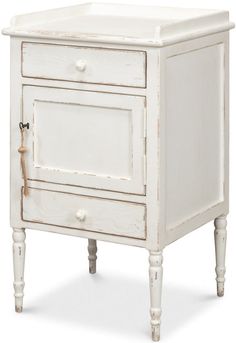 an old white cabinet with two drawers on one side and a drawer on the other