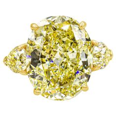 A well-crafted and color-rich three-stone engagement ring, showcasing a vibrant 13.46 carats oval cut yellow diamond certified by GIA as Fancy Intense Yellow color and VS1 clarity, set on a classic four prong basket. Flanked by two pear shape diamonds weighing 2.30 carats total certified by GIA as Fancy Intense Yellow color with VS1 and SI2 clarity, respectively. Made with 18K yellow gold. Created and stamped by Cartier. Three Stone Engagement Rings Oval, Oval Diamond Solitaire Ring, Unique Wedding Jewelry, Yellow Diamond Ring, Yellow Diamonds Engagement, Yellow Diamond Engagement Ring, White Sapphire Engagement Ring, Contemporary Engagement Rings, Oval Cut Engagement Ring