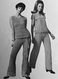 two women standing next to each other in crocheted clothing