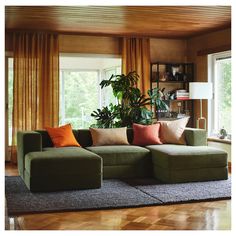 a living room filled with furniture and lots of windows