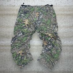 "Vintage Mossy Oak Hunting Camo Tactical Pants Field Staff Baggy Fit Cargos Crazy Woodland Pattern 90s Skate / Streetwear Great Condition: 9/10 Men's Size:  Waist: 42\" Length (inseam): 32\" Leg Opening: 9\" Thigh Opening: 15\" Front Rise: 14.5\"" Baggy Combat Cargo Pants For Outdoor, Baggy Combat Pants For Outdoor, Camouflage Techwear Pants For Outdoor Activities, Camouflage Techwear Pants For Outdoor, Tactical Camouflage Cargo Pants With Pockets, Combat Style Cargo Pants For Hunting, Camouflage Cargo Pants For Outdoor Activities, Tactical Camouflage Bottoms With Pockets, Military Style Outdoor Bottoms With Multiple Pockets