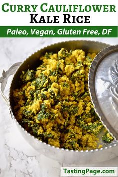 a bowl filled with rice and spinach on top of a white marble countertop