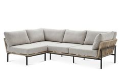 an outdoor sectional sofa with grey cushions