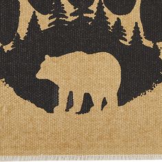 the bear is walking through the woods with trees on it's back ground,