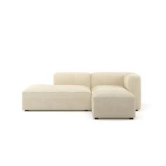 a white couch sitting on top of a white floor next to a chair and ottoman