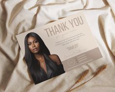 a thank card with an image of a woman's face and long black hair