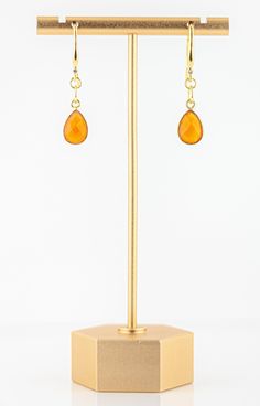 These lovely Carnelian Drop Earrings are a beautiful, bright and elegant addition to your jewelry collection. The vivid orange colored carnelian drops dangle from sparkling cubic zirconia and gold-plated ear wires. These earrings will make you smile, the color is so bright and beautiful and they easily transition from day to night! Beautiful, faceted orange carnelian vermeil bezels. Bright, gold plated ear wires adorned with a sparkling cubic zirconia stone. 1 inch long. Natural variations in th Amber Carnelian Gemstone Earrings, Orange Carnelian Gemstone Earrings, Orange Gemstone Dangle Earrings, Amber Carnelian Earrings With Ear Wire, Gold Carnelian Earrings With Ear Wire, Carnelian Gold Earrings With Ear Wire, Carnelian Teardrop Earrings For Gift, Orange Gemstone Drop Earrings, Carnelian Amber Earrings For Gift