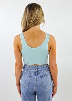 This aqua crop tank top is a must have! It features a twisted detail that can be worn on either the front or the back. We love the versatility and comfort! Complete the look with the Truth Hurts Shorts ★ Medium Wash Denim. Model Info Meet Helena! These are one size. Hips: 35" l Waist: 26" l Bust: 33" l Height: 5'6" space The Details Crop Tank Reversible 92% Nylon 8% Spandex Beach Tank Crop Top With Built-in Bra, Trendy Sports Bra With Built-in Bra For Spring, Sporty Crop Top With Medium Bust Support For Summer, Summer Workout Crop Top With Medium Bust Support, Solid Summer Crop Top With Medium Bust Support, Solid Color Summer Crop Top With Medium Bust Support, Athleisure Summer Crop Top With Medium Bust Support, Versatile Summer Crop Top Sports Bra, Versatile Cropped Sports Bra For Summer