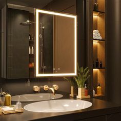 a bathroom with a sink, mirror and lights on the wall above it's counter