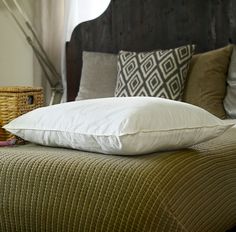 a bed with two pillows on top of it