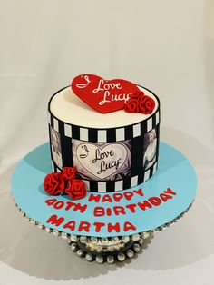 a birthday cake with the words i love you written on it and two red roses