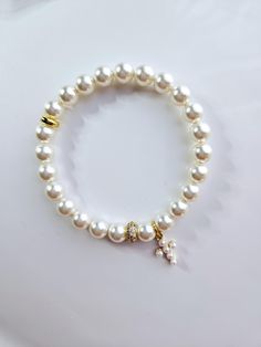 This beautiful bracelet is made with 8mm white Austrian crystal pearls and 14 kt gold filled white pearl cross charm. This bracelet is sold gift wrapped Pearl Rosary Bracelet With Pearl Charm, Pearl Rosary Bracelet With Round Beads And Pearl Charm, Elegant White Charm Bracelet With 8mm Beads, White Pearl Charm Bracelet For First Communion, White Pearl Charm Bracelet, White Pearl Rosary Bracelet With Pearl Charm, Elegant Pearl Rosary Bracelet For Baptism, White Hypoallergenic Pearl Bracelet For First Communion, Hypoallergenic White Pearl Bracelet For First Communion