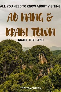 the words ao nang & krabi town are in front of green mountains