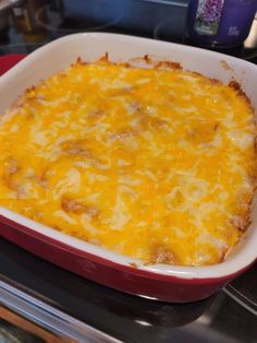 a casserole dish with cheese and meat in it on top of the stove