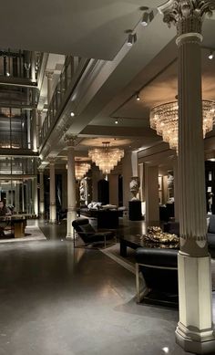 an elegant lobby with chandeliers and couches