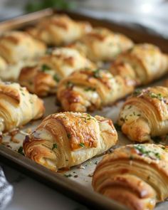 there are many croissants on the baking sheet