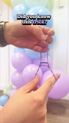 someone is trying to tie the string with balloons in the background that says, did you know this trick?