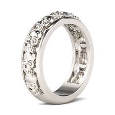 a white gold ring with skulls and diamonds on the inside, set in 18k white gold