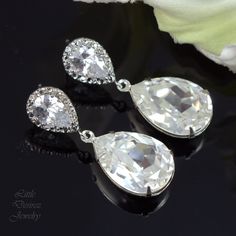 "Swarovski Crystal Clear Earrings Bridal Earrings Bridesmaid Gift Wedding Jewelry Teardrop Earring White Jewelry Cubic Zirconia Crystal Earrings Elegant and romantic Swarovski Clear Crystal Earrings..offering the expensive, rich look of precious gemstones at a fraction of the cost! Earrings made with: - the gorgeous and unique 18x13mm Swarovski teardrop pear shaped fancy stones in Crystal Clear, set in sterling silver plated settings - Hypoallergenic, Rhodium plated and tarnish resistant .925 St Wedding Teardrop Pendant Earrings For Pierced Ears, Silver Teardrop Earrings For Wedding, Diamond White Teardrop Bridal Earrings As Gift, Silver Drop Earrings For Bridal Shower, Gift Bridal Earrings In Diamond White Teardrop Shape, Diamond White Bridal Earrings For Gifts In Teardrop Shape, Teardrop Crystal Earrings For Wedding, Pear-shaped Wedding Earrings, Diamond White Teardrop Crystal Earrings For Wedding