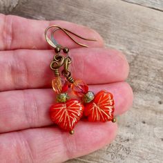 "These beaded dangle earrings are sure to add a pop of color to your wardrobe. They are just stunning! These earrings are 1.5\" in length. The smaller beads are 3 x 5mm. The leaf bead is 10 x 13mm. The ear wire shown on the earrings is a commercially made antique brass wire or titanium. If you order titanium, the ear wire is handmade. To find other items in this series, try this link. https://www.etsy.com/shop/CraftLikeAnArtist?ref=l2-shopheader-name&search_query=autumn+series16 Titanium is Orange Czech Glass Dangle Earrings, Czech Glass Beaded Earrings For Pierced Ears, Adjustable Czech Glass Earrings With Ear Wire, Pierced Czech Glass Drop Earrings, Pierced Czech Glass Dangle Earrings, Nickel Free Czech Glass Dangle Earrings, Nickel-free Czech Glass Drop Earrings, Gift Crystal Earrings With Czech Glass, Czech Glass Earrings As A Gift