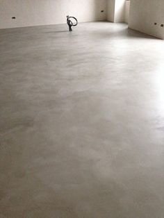 an empty room with white walls and no one on the floor in front of it