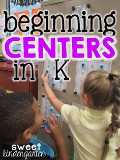 two children are playing with letters and numbers on the wall in front of a desk