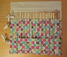 a close up of a bag on a wooden table with clothes pins and buttons attached to it