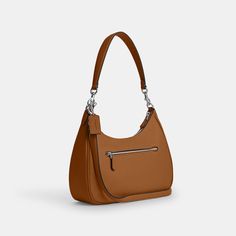 Inspired by the relaxed style of classic hobo silhouettes our Teri Hobo Bag is the perfect size to wear comfortably every day (while still carrying all your necessities). Crafted of refined pebble leather this leather hobo bag fits your essentials—phone keys and wallet—and keeps them secure with a zip closure. You can wear this pebbled leather crossbody bag two ways thanks to a detachable handle and strap that make it extra versatile. For added organization there’s even an outside zip pocket and Textured Leather Saddle Bag For Travel, Classic Shoulder Bag With Silver-tone Hardware For Everyday, Classic Textured Leather Baguette Bag, Classic Shoulder Bag With Silver-tone Hardware, Classic Textured Leather Shoulder Bag For On-the-go, Classic Hobo Bag With Silver-tone Hardware For Everyday Use, Classic Textured Leather Crossbody Hobo Bag, Everyday Use Baguette Bag With Silver-tone Hardware, Classic Saddle Bag With Silver-tone Hardware For Everyday