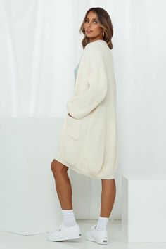 Length from shoulder to hem of size S/M: 93cm. Cream knit cardigan. Non-lined. Cold hand wash only. Model is a standard XS and is wearing size S/M. True to size. Mid-weight, stretchy purl knit fabric. Open front. No zipper. Slip-on style. Wool/Acrylic.
 My my my! Another knit cardigan and a sartorial winter/workwear essential for your wardrobe! We admit we love this cosy edit's oversized silhouette and exaggerated bouffant sleeves. Yes, this open-front knit cardigan comes with pockets! We're tea Cozy Stretch White Cardigan, Cozy White Stretch Cardigan, Casual Cream Ribbed Cardigan, Casual Ribbed Cream Cardigan, Beige Stretch Knit Cardigan, Beige Stretch Knitted Cardigan, Beige Knitted Stretch Cardigan, Cotton Knitted Sweater Coat, Beige Stretch Ribbed Cardigan