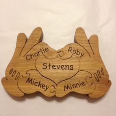 a wooden plaque with two hands holding hearts