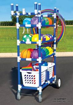 a toy cart with balls and other toys on it's wheels in a parking lot