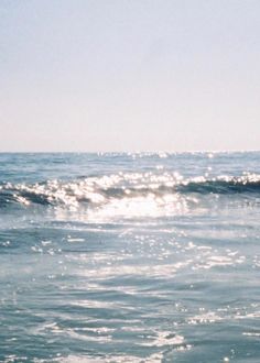 a man riding a wave on top of a surfboard