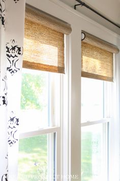 two windows with roman shades in them and the blinds are made out of bamboo paper