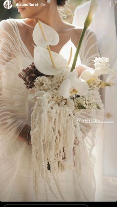 a woman in a white dress holding a bouquet of flowers