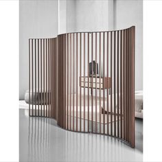 a room divider made out of wooden slats in an empty room with white walls