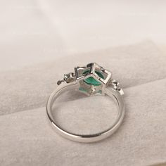 ◆The ring draws inspiration from the polaris. Hand-finished in Sterling sliver, this piece features a round shaped emerald . Clear zirzons decorate around the main stone. An extremely simple celestial ring that you cannot miss. ◆ Production Description: Main stone Type: Emerald Main Stone Shape: Round Main Stone Size:7*7mm(1.30ct) Side stone: CZ Metal: 925 Sterling silver - Other options available in the drop down menu ◆ Customization: √Free for Add Engraving √Other Metal Type Available √Other G Silver Emerald Birthstone Ring, Silver Diamond Emerald Ring Birthstone, Silver Emerald Ring With Diamond, Silver Moissanite Emerald Ring For Gift, Silver Emerald Cluster Ring, Silver Emerald Ring, Round Cut, Silver Diamond Ring With Emerald Birthstone, Silver Emerald Ring With Diamond In Open Ring Style, Fine Jewelry Silver Emerald Ring